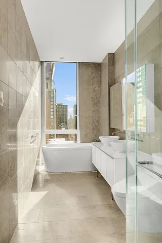 a spacious bedroom with a bed and a large window