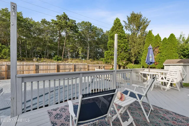 a front view of a house with swimming pool patio and outdoor seating