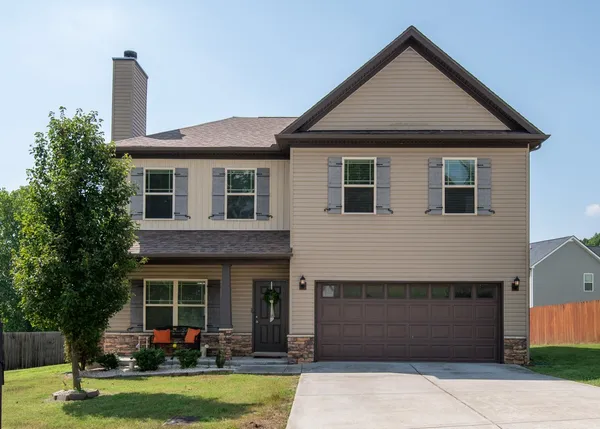 a front view of a house with garden