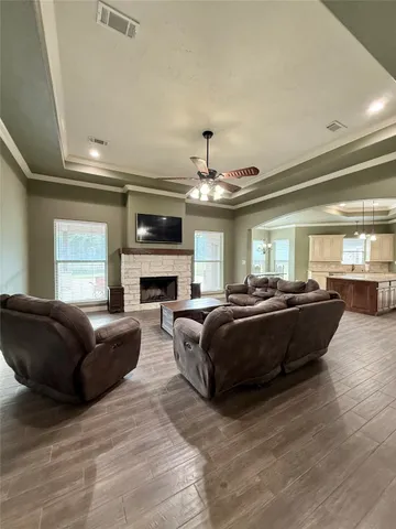 a large kitchen with stainless steel appliances refrigerator a stove and a wooden floors