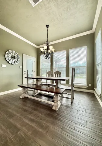 a large kitchen with stainless steel appliances kitchen island granite countertop a large counter top and white cabinets