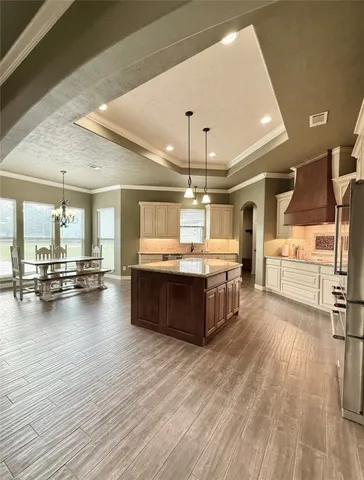 a large kitchen with stainless steel appliances a large counter top