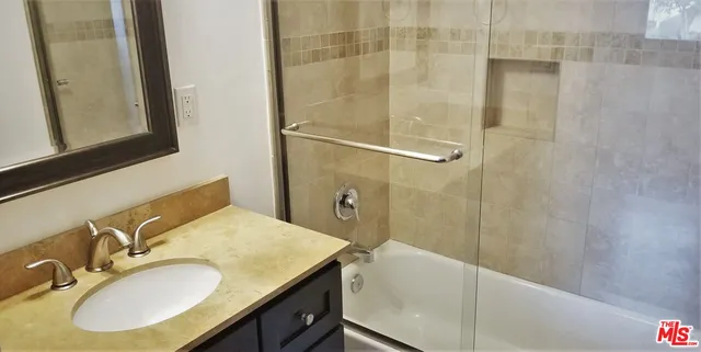 an empty room with wooden floor and closet