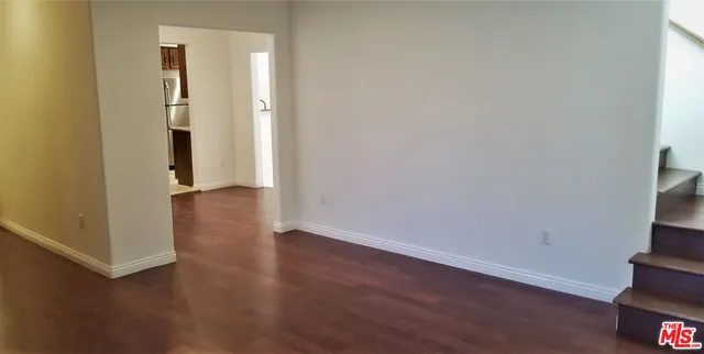an empty room with wooden floor and closet