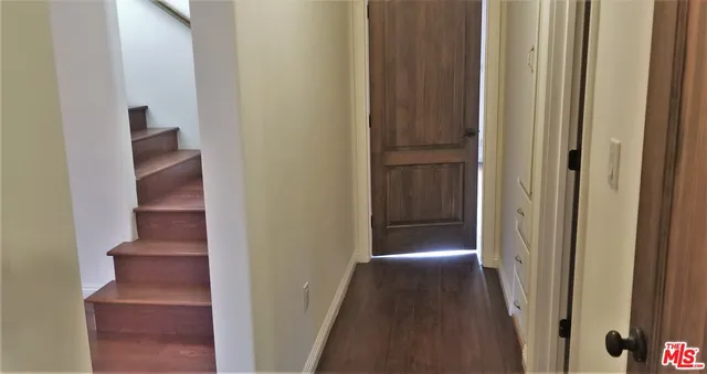 an empty room with wooden floor and a window