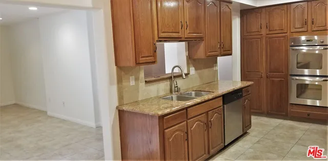 a kitchen with stainless steel appliances granite countertop a sink and cabinets