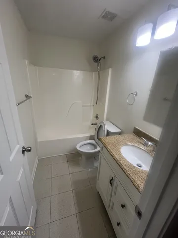 an empty room with windows and sink