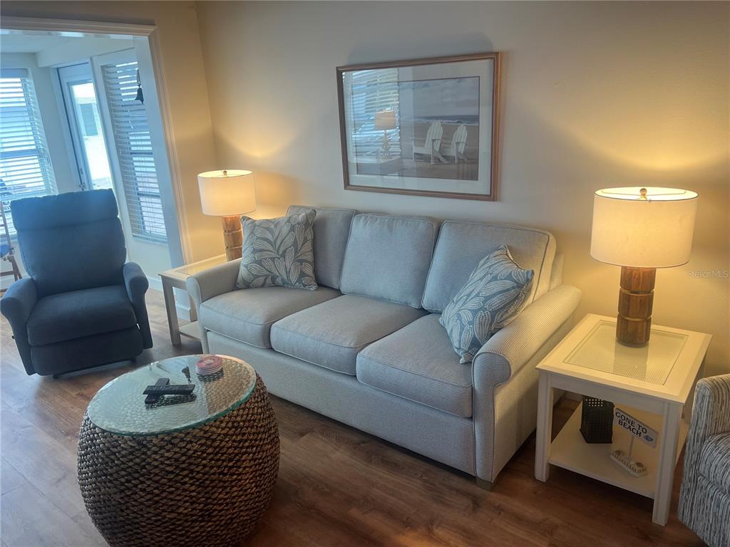 6020 Midnight Pass Road, Unit 38 Sarasota, FL 34242 - Photo 3 of 11 a living room with furniture and a lamp