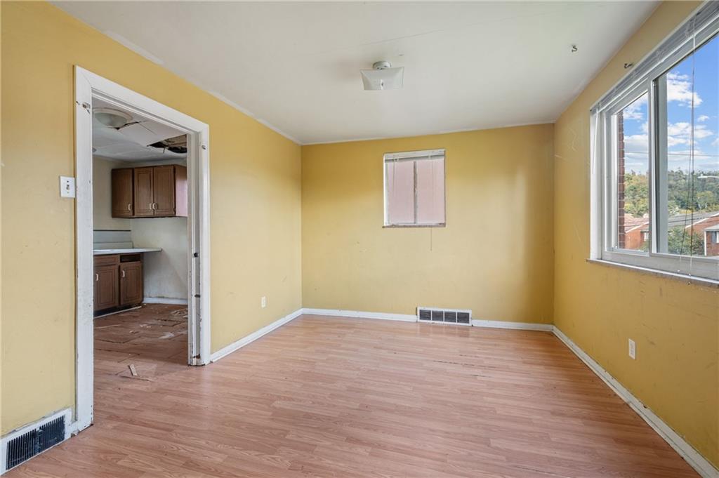 917 Liberty Street McKees Rocks, PA 15136 - Photo 8 of 14 a view of empty room with wooden floor and fan