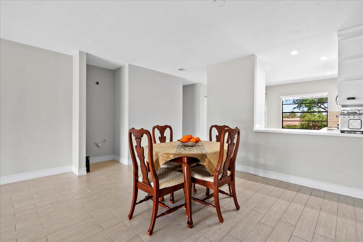 21719 Arriba Real, Unit J Boca Raton, FL 33433 - Photo 11 of 33 a view of a dining room with furniture