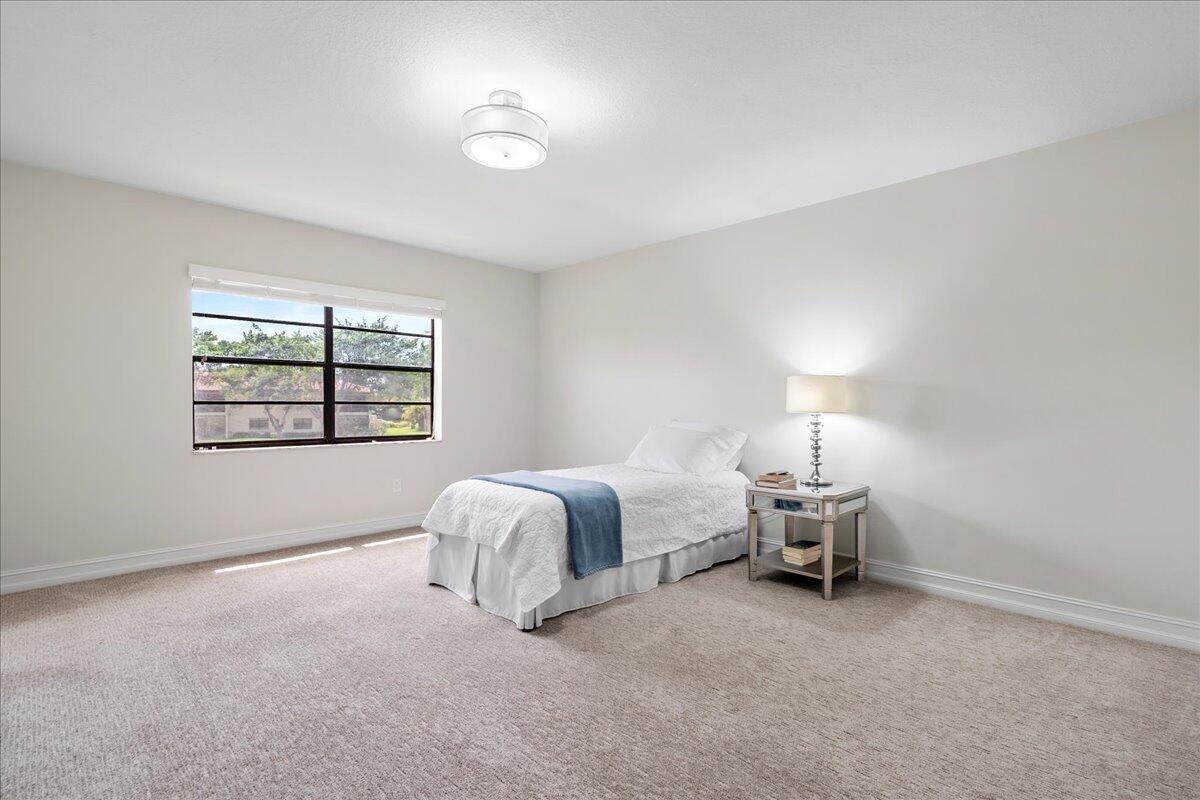 21719 Arriba Real, Unit J Boca Raton, FL 33433 - Photo 13 of 33 a bed room with a bed and a window