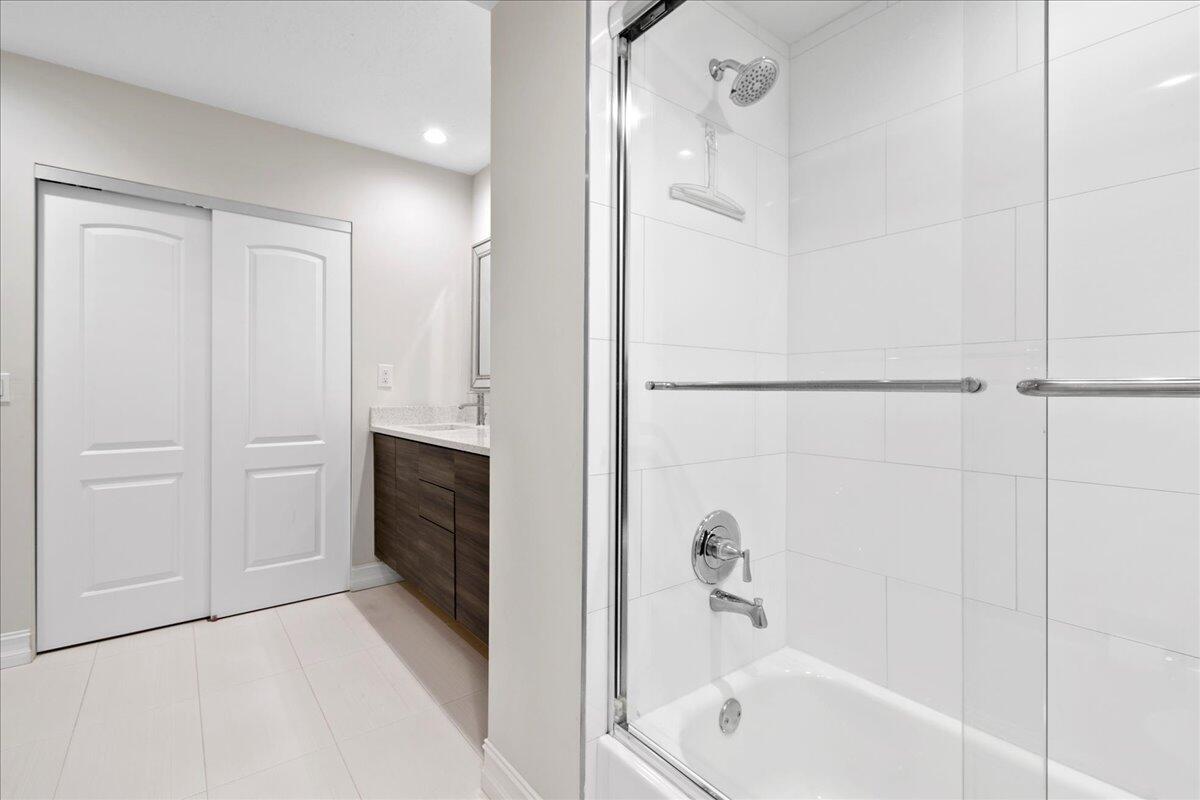 21719 Arriba Real, Unit J Boca Raton, FL 33433 - Photo 16 of 33 a bathroom with a bathtub and a shower