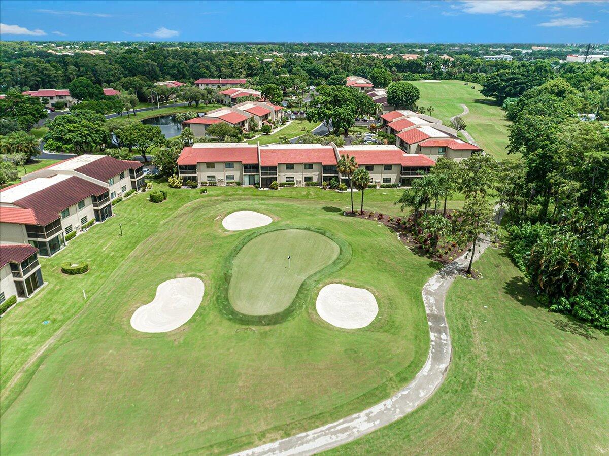 21719 Arriba Real, Unit J Boca Raton, FL 33433 - Photo 24 of 33 a view of a golf course with a swimming pool