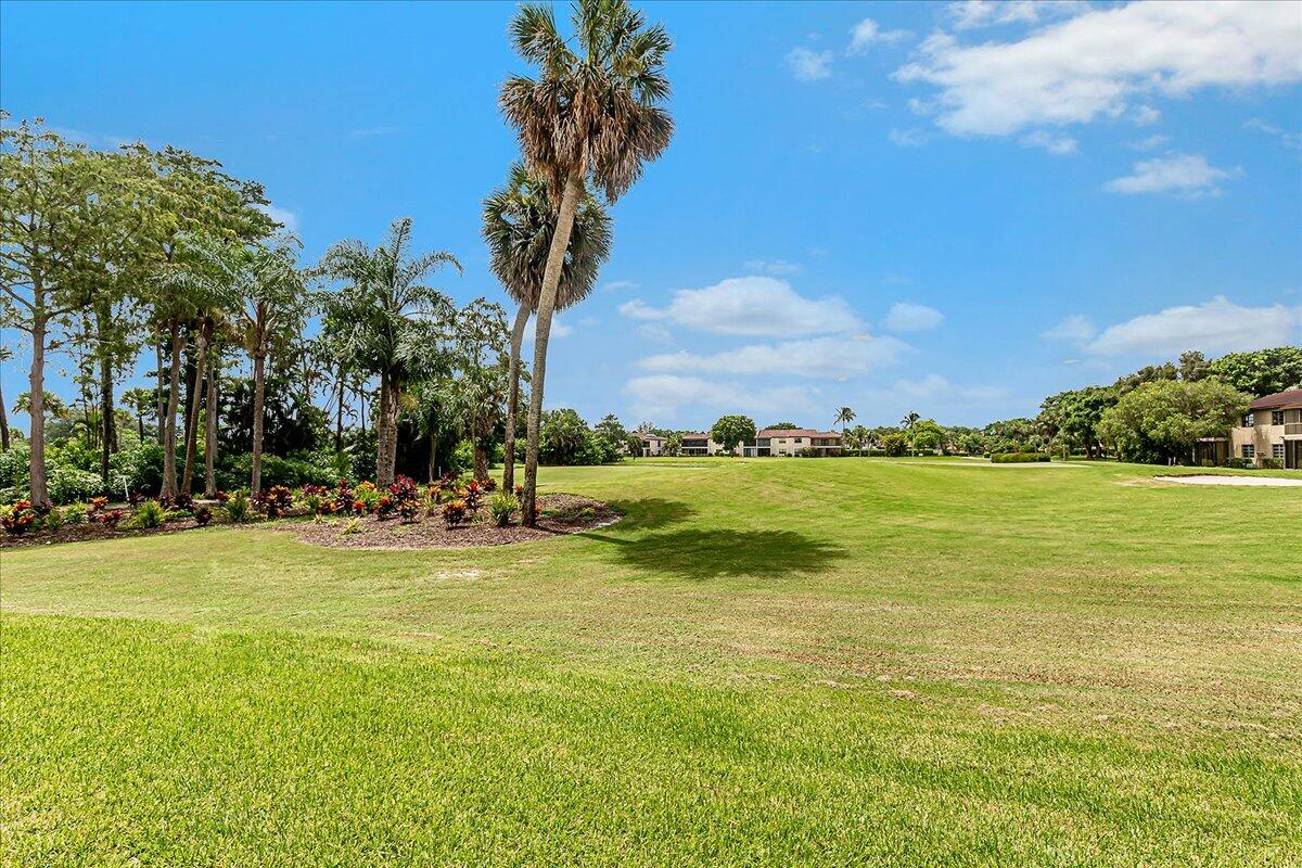 21719 Arriba Real, Unit J Boca Raton, FL 33433 - Photo 25 of 33 a view of a lake with houses in the background