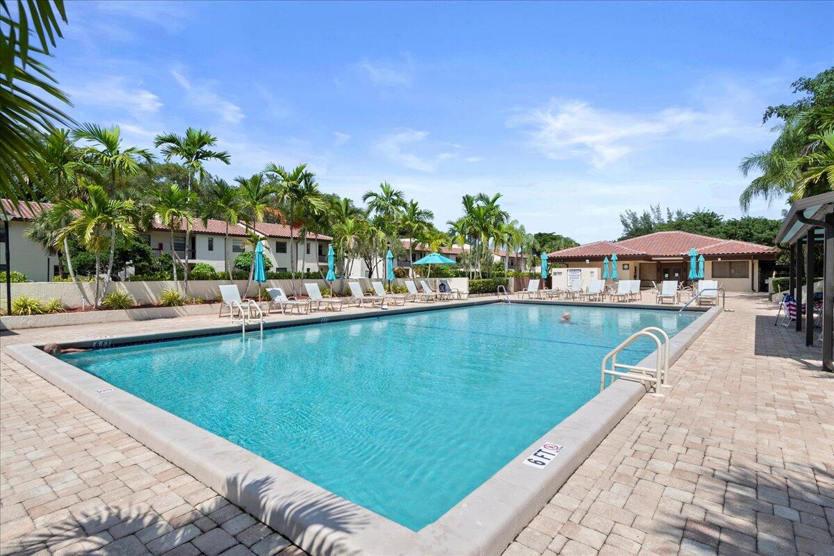 21719 Arriba Real, Unit J Boca Raton, FL 33433 - Photo 32 of 33 a view of swimming pool with outdoor seating and plants