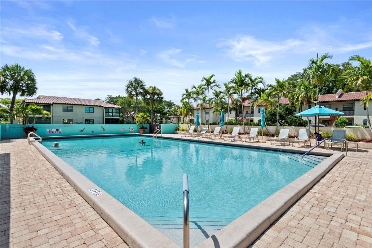 21719 Arriba Real, Unit J Boca Raton, FL 33433 - Photo 33 of 33 a view of swimming pool with outdoor seating and plants