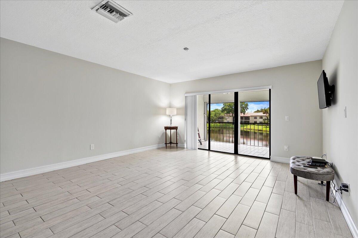 21719 Arriba Real, Unit J Boca Raton, FL 33433 - Photo 6 of 33 a view of a room with a flat screen tv and a window