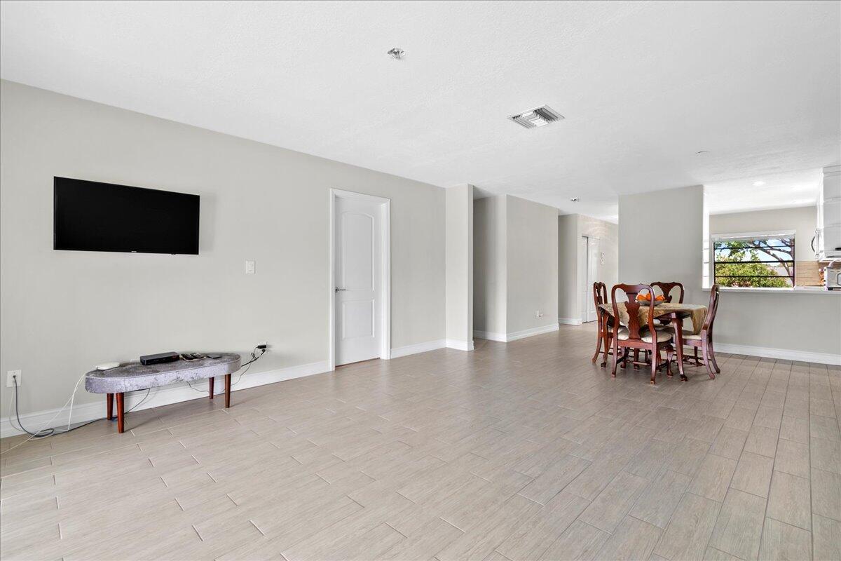21719 Arriba Real, Unit J Boca Raton, FL 33433 - Photo 9 of 33 a living room with furniture and a flat screen tv