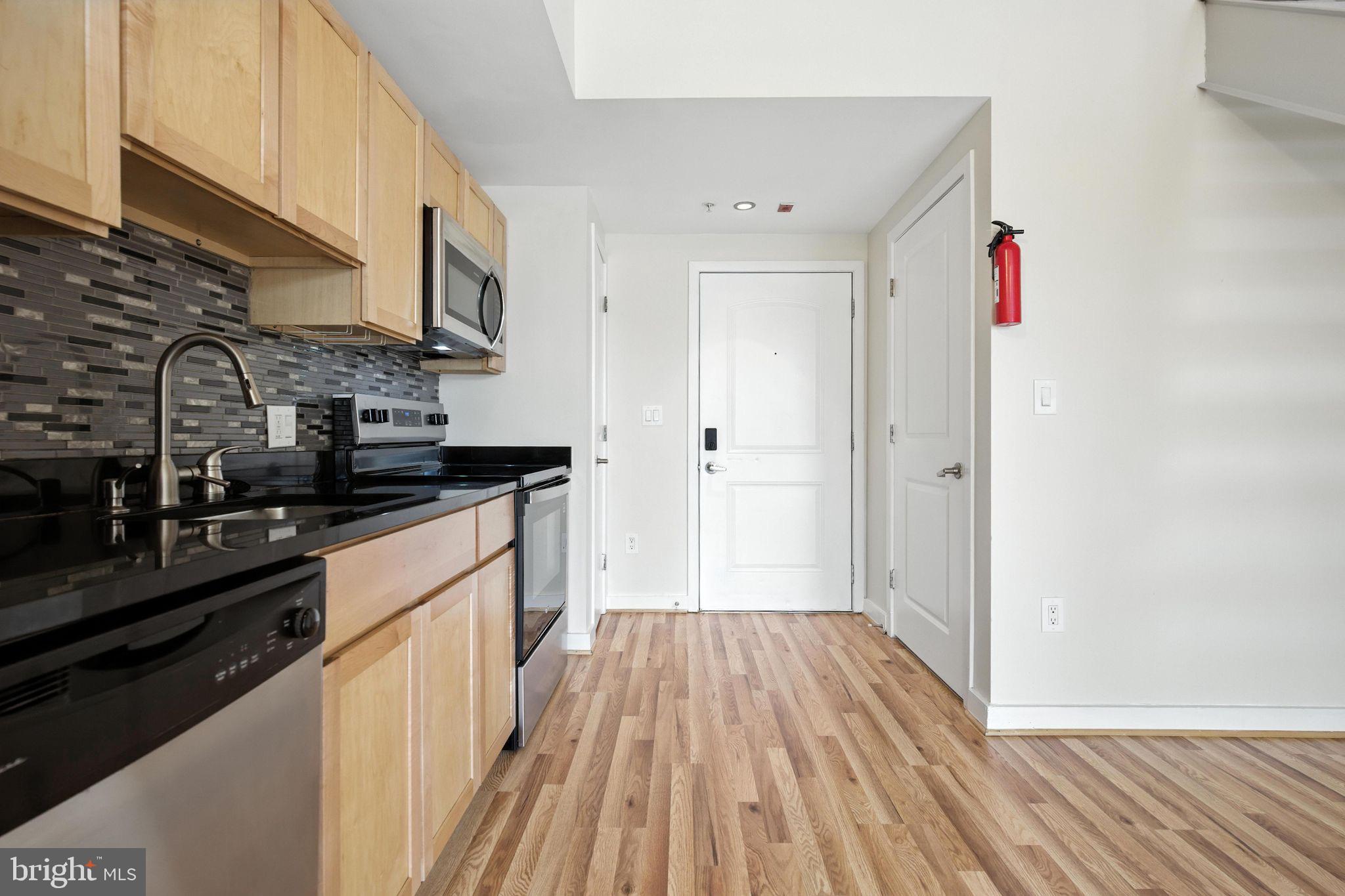 5885 Colorado Avenue Northwest, Unit 208 Washington, DC 20011 - Photo 12 of 27 a kitchen with stainless steel appliances a refrigerator and a stove top oven