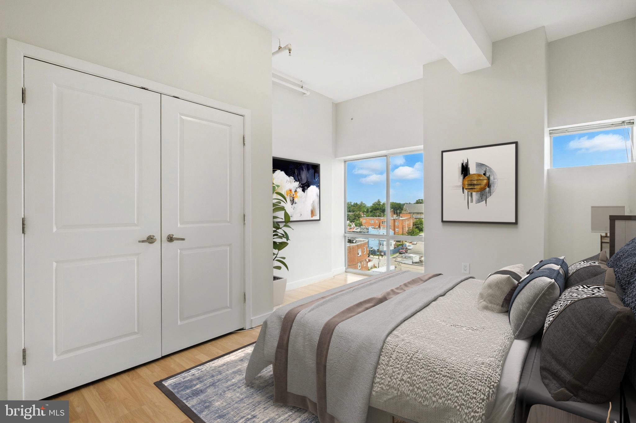 5885 Colorado Avenue Northwest, Unit 208 Washington, DC 20011 - Photo 14 of 27 a bedroom with a bed and a painting on the wall