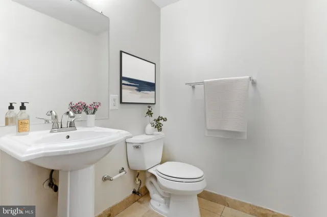 a bathroom with a sink a toilet and mirror