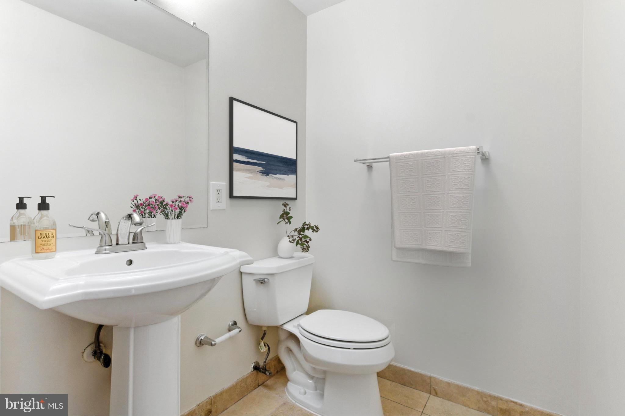 5885 Colorado Avenue Northwest, Unit 208 Washington, DC 20011 - Photo 16 of 27 a bathroom with a sink a toilet and mirror