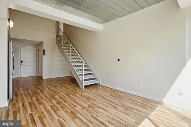 a view of an empty room with wooden floor