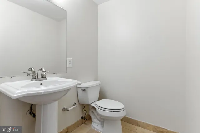 a bathroom with a sink a toilet and mirror