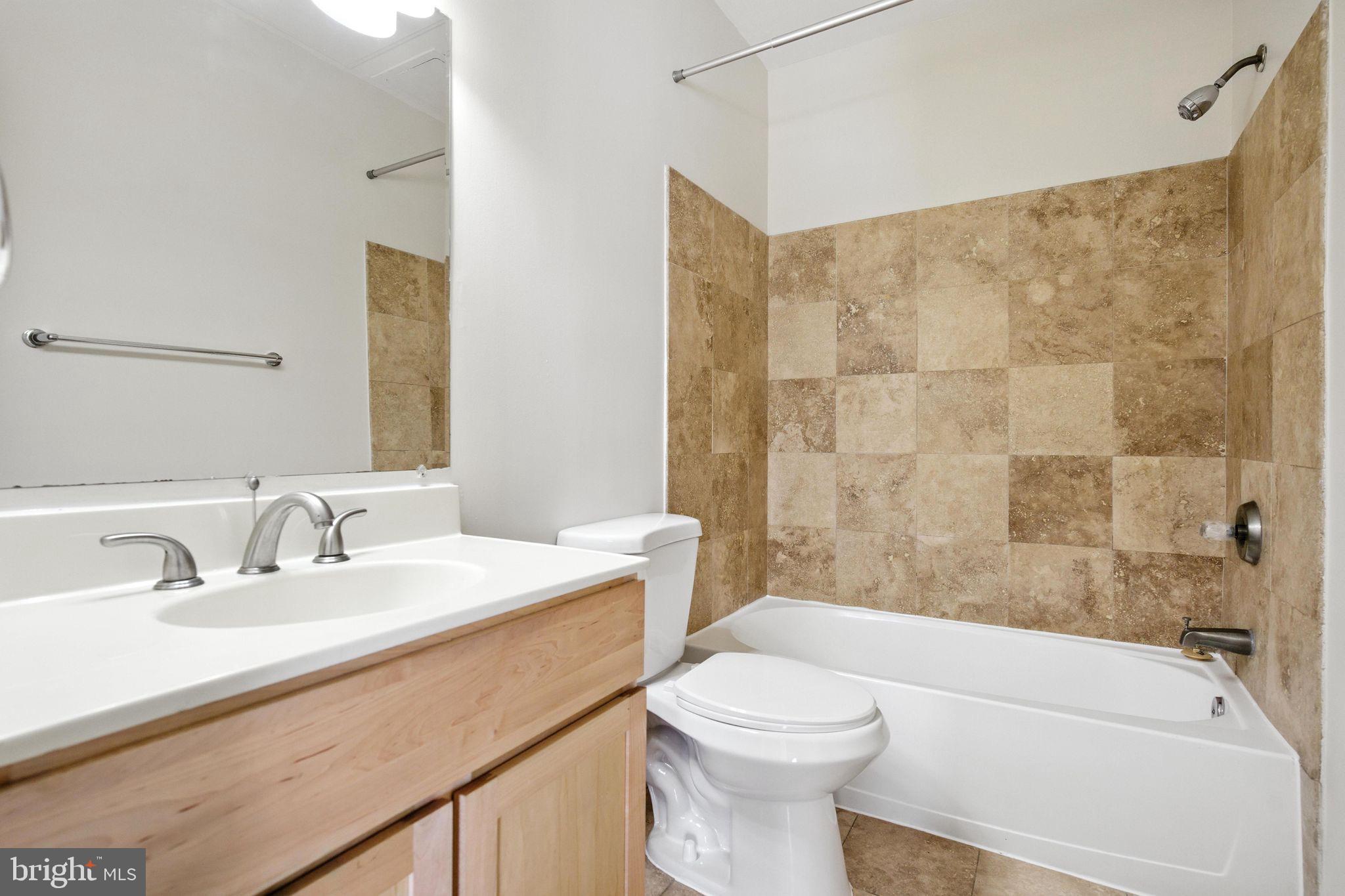 5885 Colorado Avenue Northwest, Unit 208 Washington, DC 20011 - Photo 20 of 27 a bathroom with a sink a toilet and a bathtub