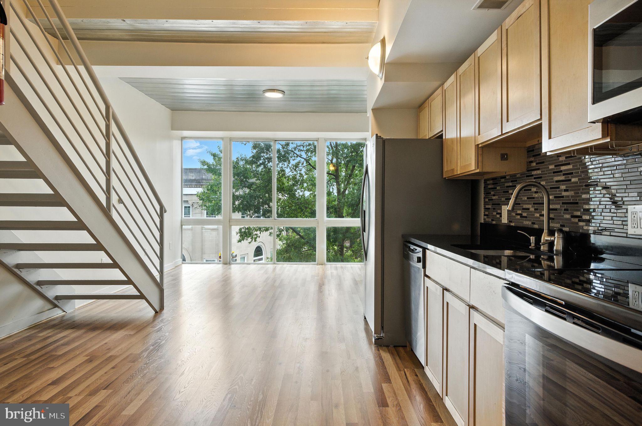 5885 Colorado Avenue Northwest, Unit 208 Washington, DC 20011 - Photo 2 of 27 a kitchen with wooden floors and a sink