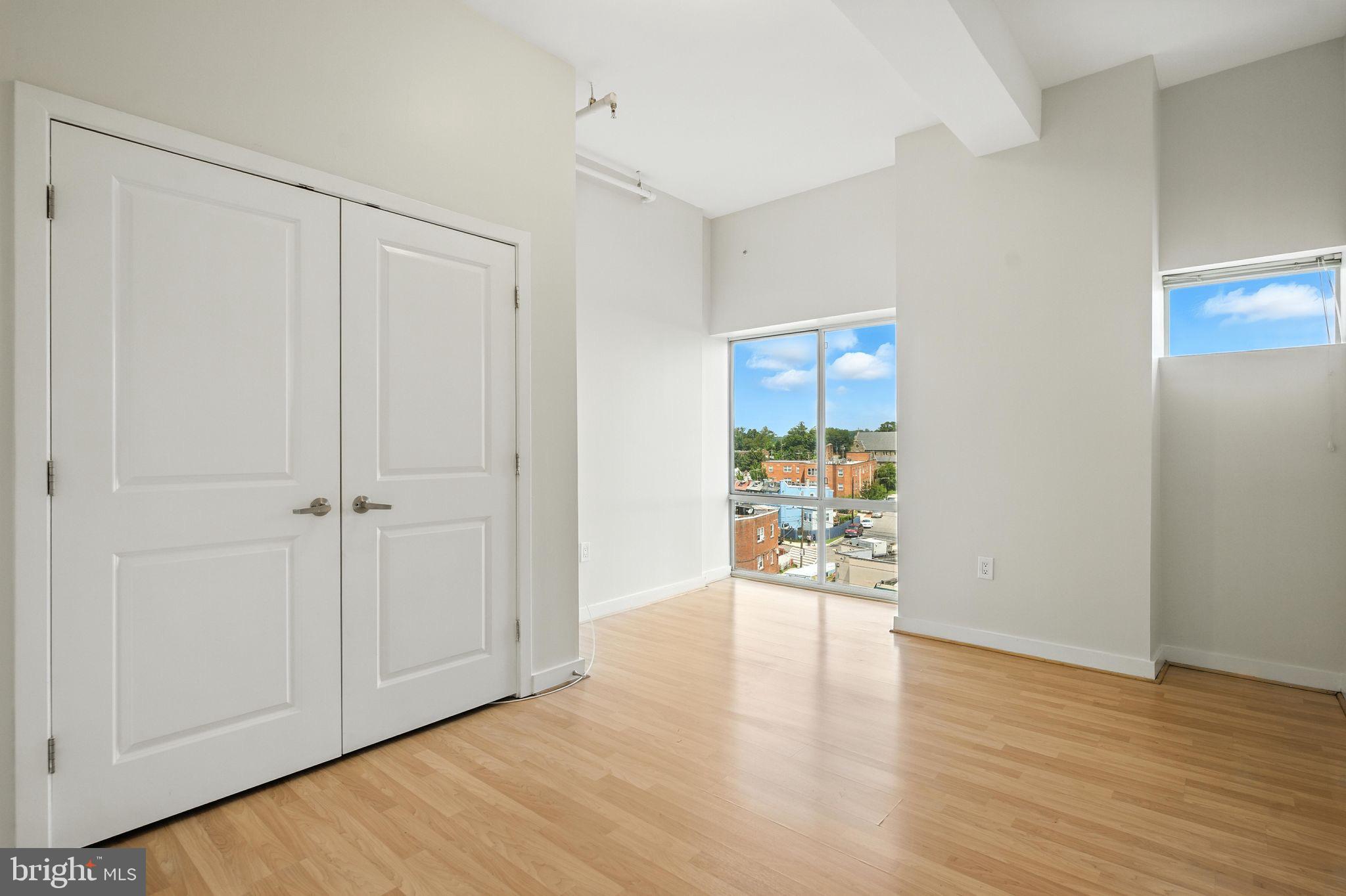5885 Colorado Avenue Northwest, Unit 208 Washington, DC 20011 - Photo 23 of 27 a view of an empty room and wooden floor