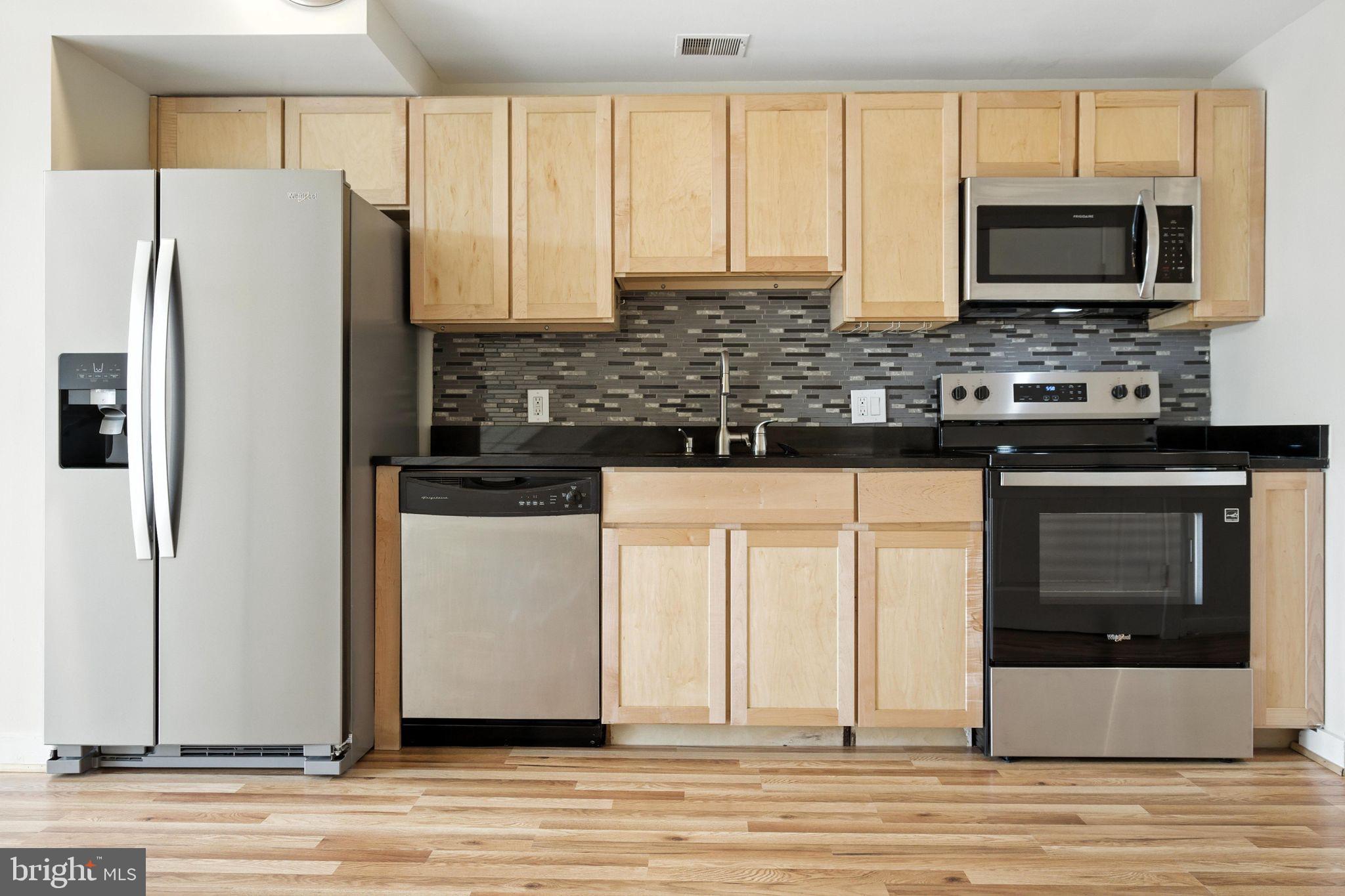 5885 Colorado Avenue Northwest, Unit 208 Washington, DC 20011 - Photo 9 of 27 a kitchen with stainless steel appliances a stove microwave and refrigerator