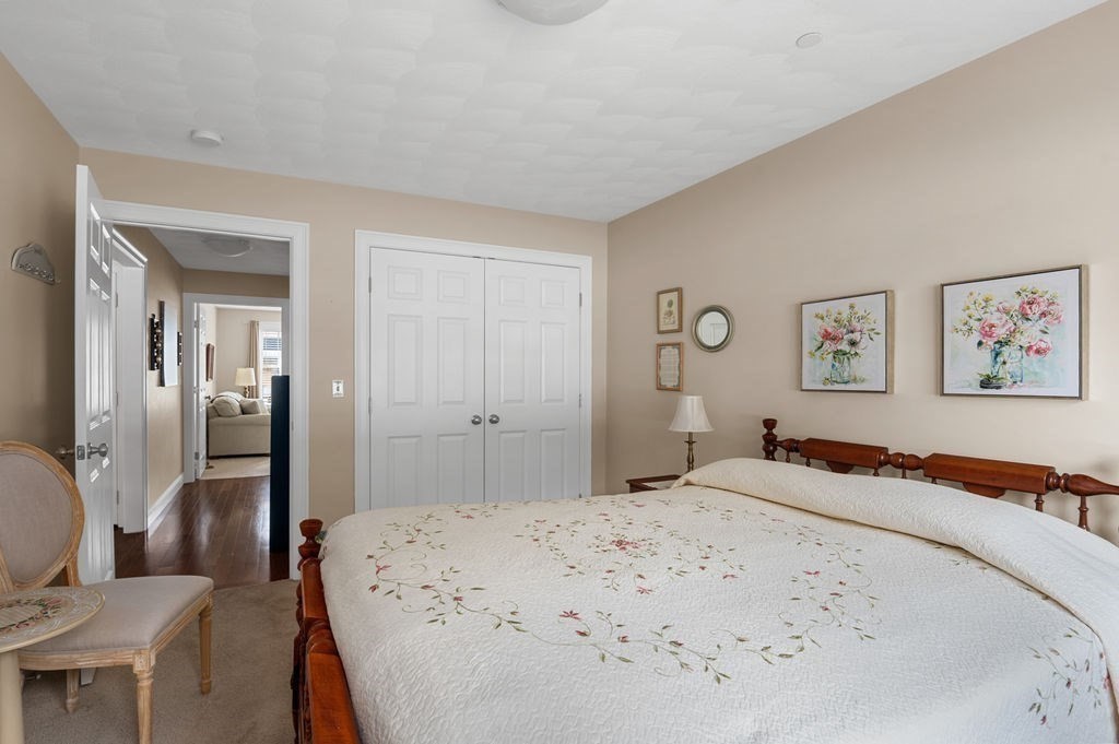13 Freedom Way, Unit 13 Merrimac, MA 01860 - Photo 15 of 26 a bedroom with a bed and painting on the wall