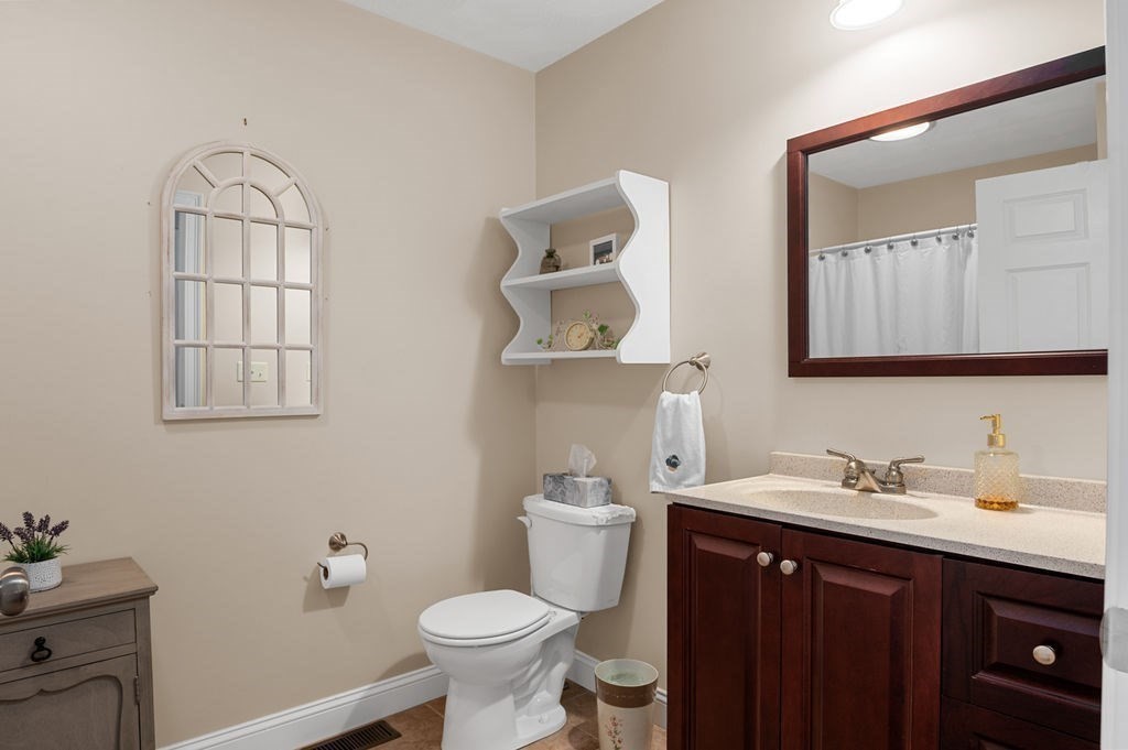 13 Freedom Way, Unit 13 Merrimac, MA 01860 - Photo 16 of 26 a bathroom with a toilet sink and mirror