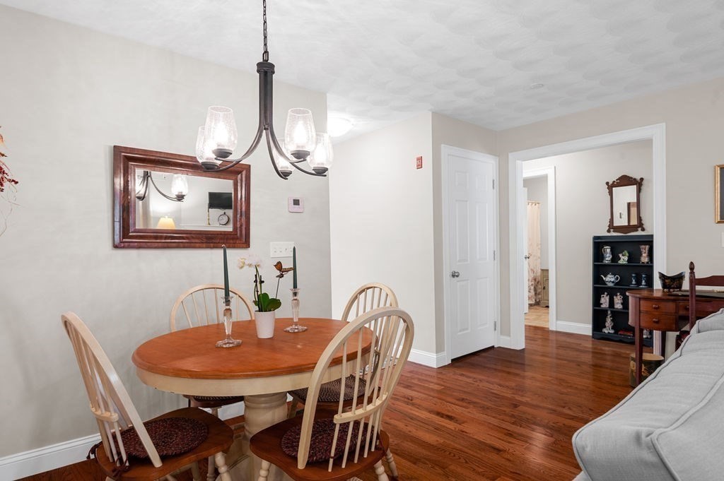 13 Freedom Way, Unit 13 Merrimac, MA 01860 - Photo 6 of 26 a view of a dining room with furniture and wooden floor