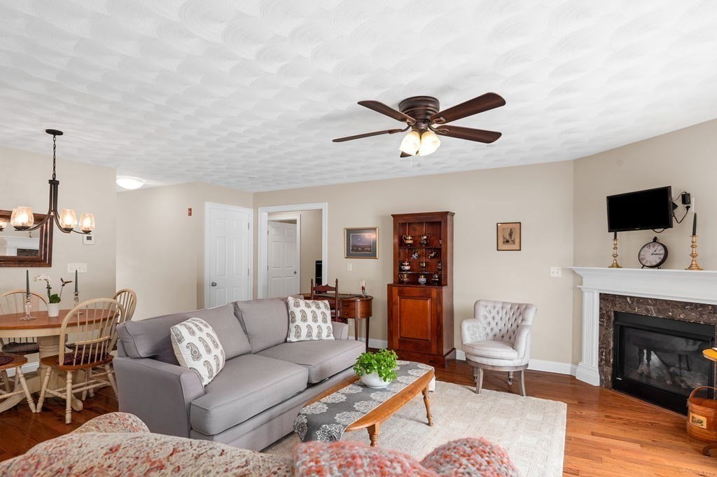 13 Freedom Way, Unit 13 Merrimac, MA 01860 - Photo 10 of 26 a living room with furniture a flat screen tv and a fireplace