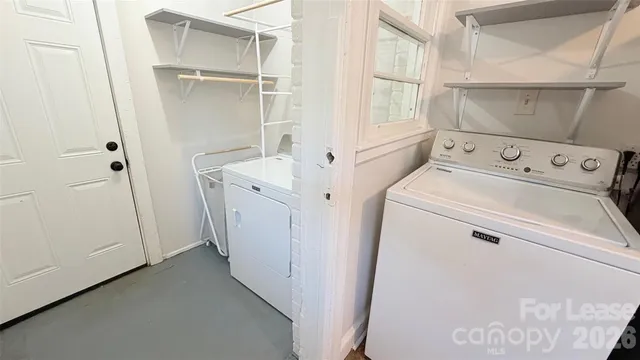 a view of storage and utility room with washer and dryer