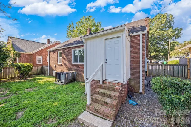a view of a house with backyard porch and sitting area