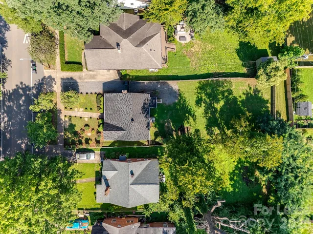 an aerial view of a house with a yard swimming pool outdoor seating and yard