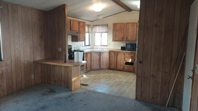 a kitchen with sink cabinets and window
