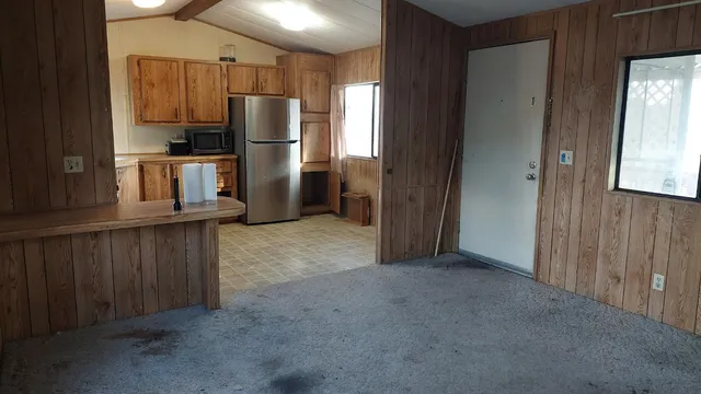 a kitchen with refrigerator and window