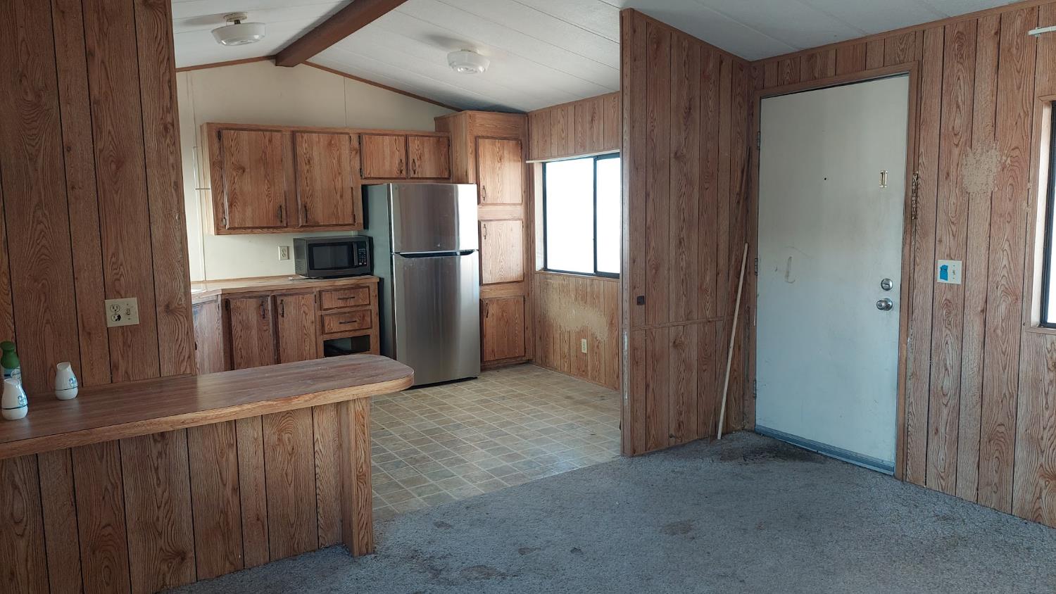 11037 Erickson Way, Unit 87 Redding, CA 96003 - Photo 6 of 10 a view of a kitchen with refrigerator and a sink