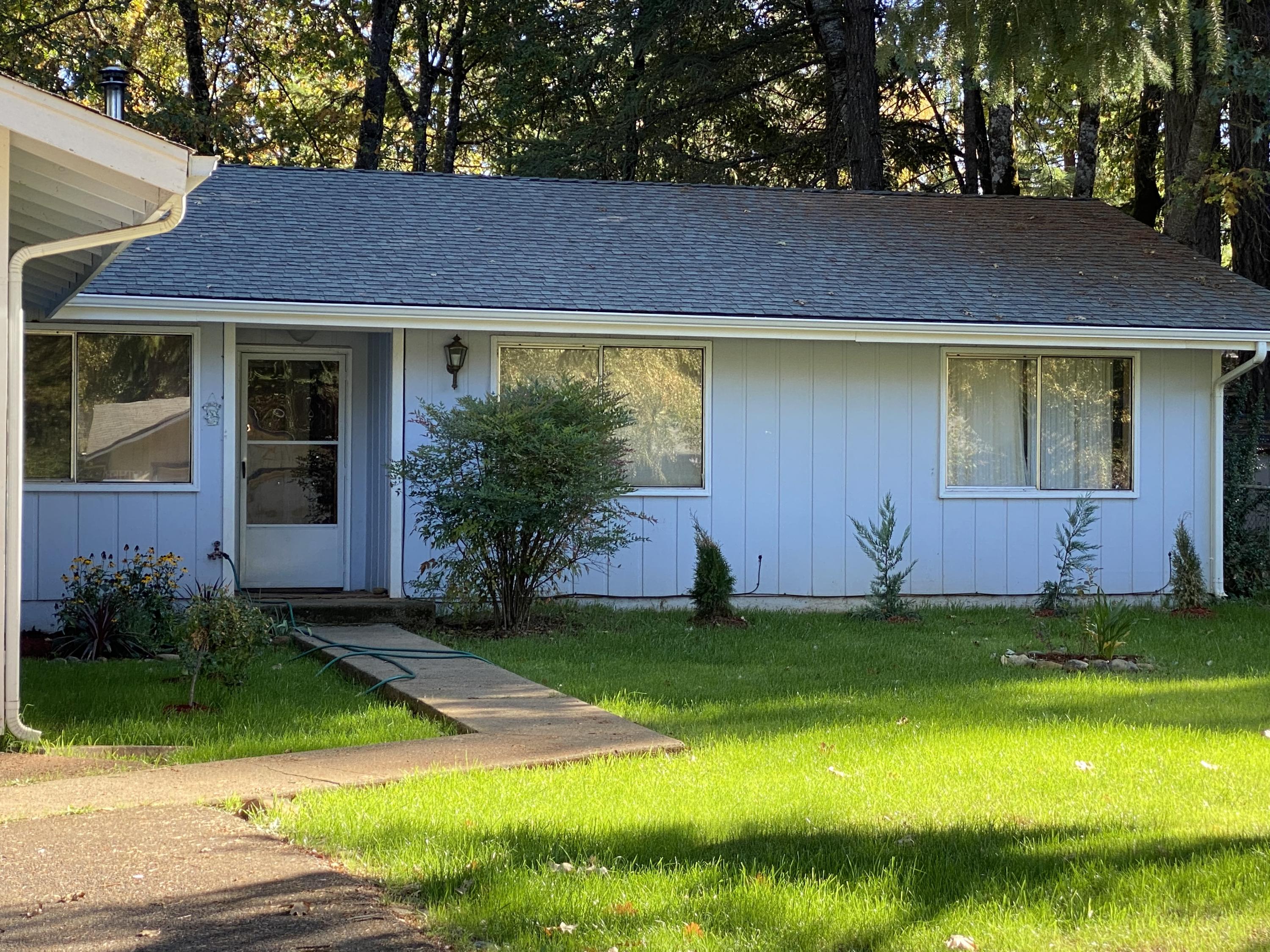 217 Shadowbrook Drive Cave Junction, OR 97523 - Photo 4 of 25 Front picture with old metal windows, see below with new vinyl windows just installed.