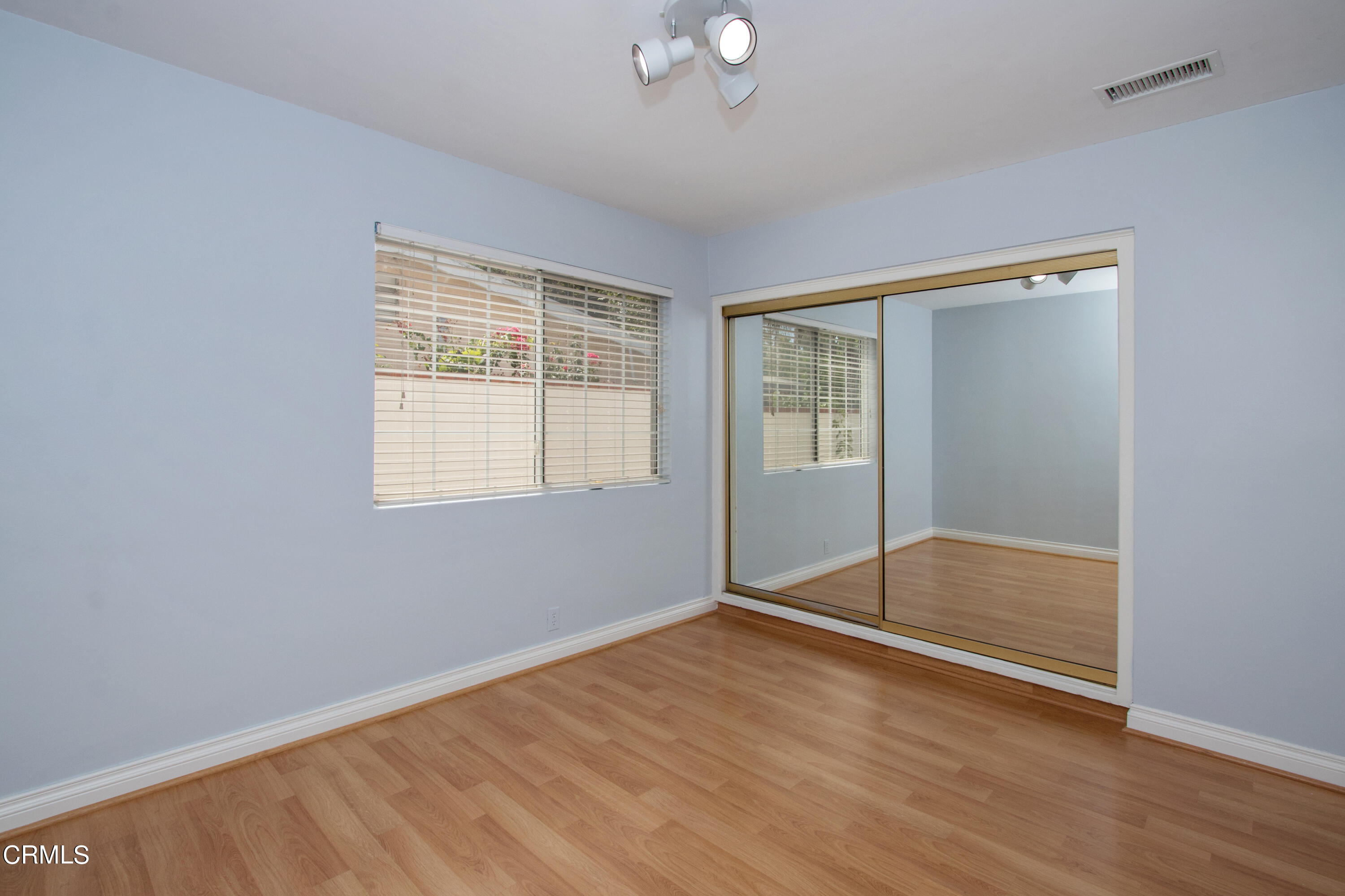 1029 Cynthia Avenue Pasadena, CA 91107 - Photo 13 of 19 an empty room with wooden floor and windows