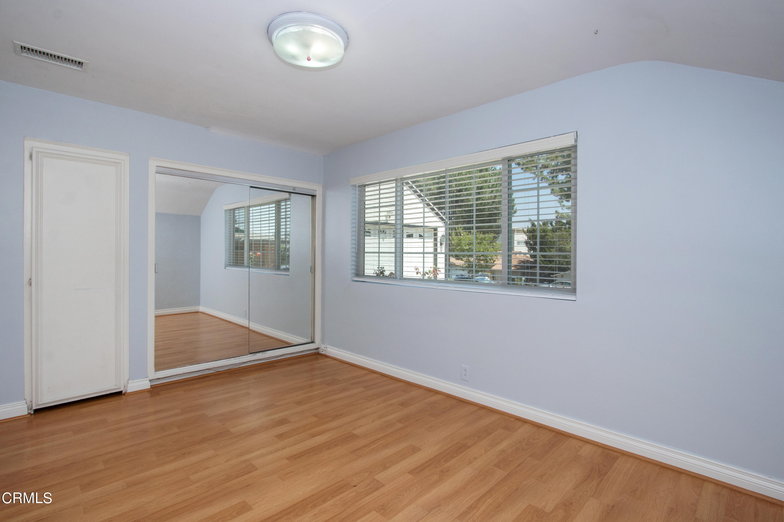 1029 Cynthia Avenue Pasadena, CA 91107 - Photo 14 of 19 an empty room with wooden floor and windows