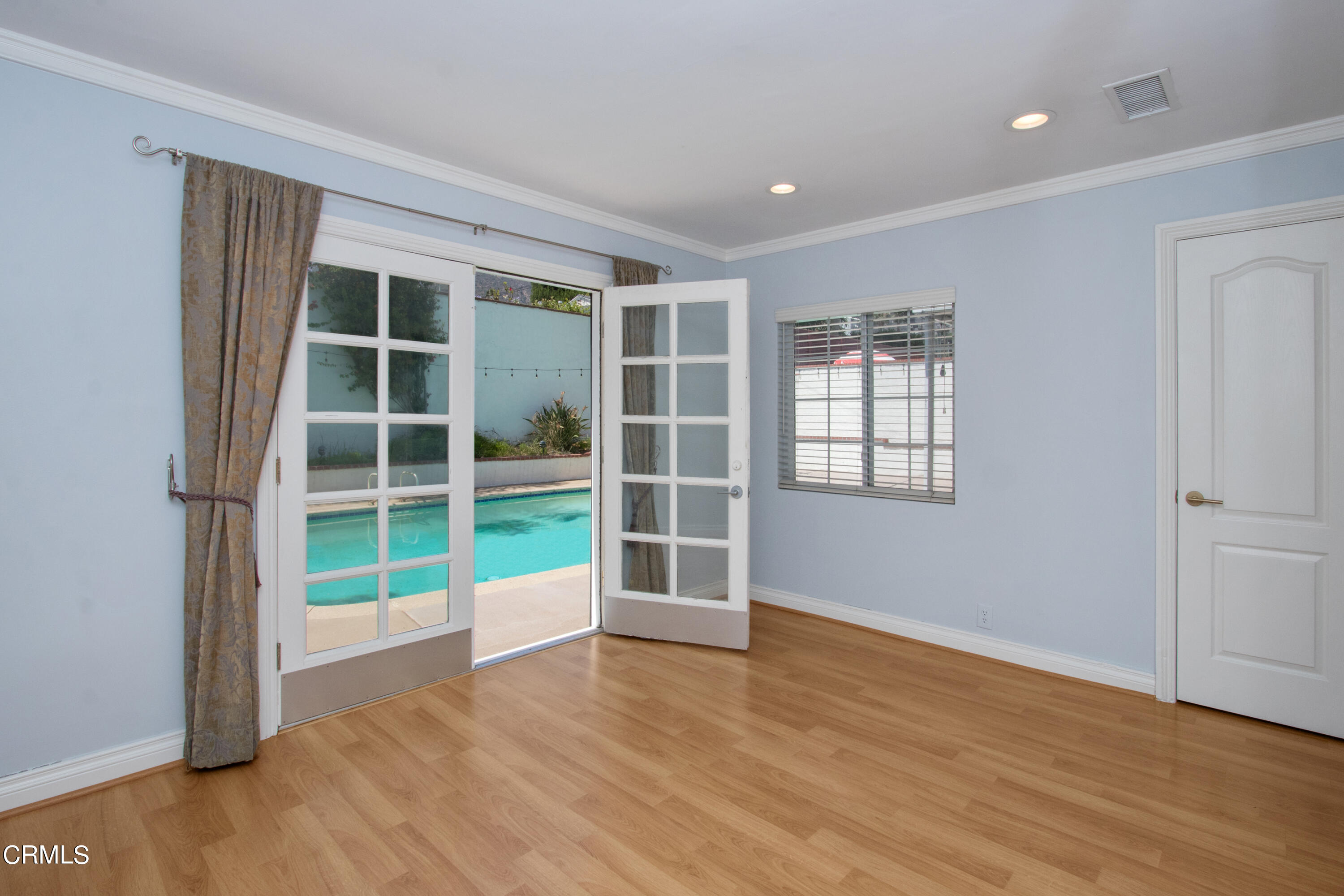 1029 Cynthia Avenue Pasadena, CA 91107 - Photo 10 of 19 an empty room with wooden floor and windows