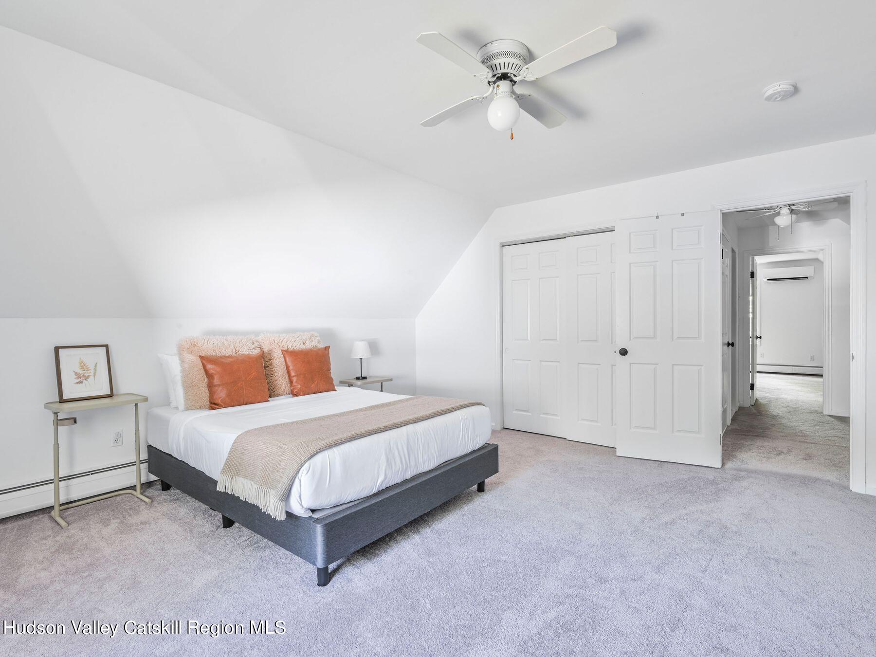 14 Red Maple Road Shokan, NY 12481 - Photo 25 of 34 a bedroom with a bed and a chandelier