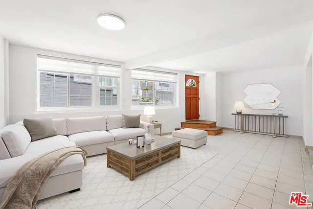 a bedroom with furniture and a large window