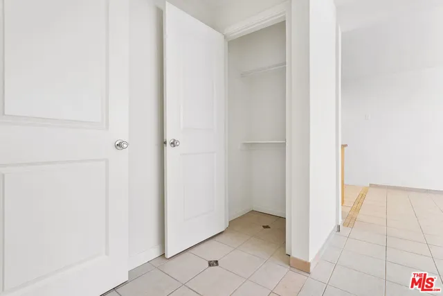 a white sink sitting under a bathroom mirror