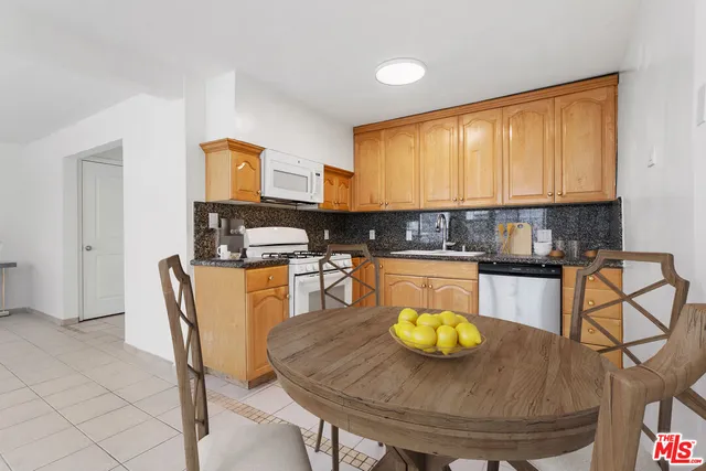 a kitchen with dining table and chairs